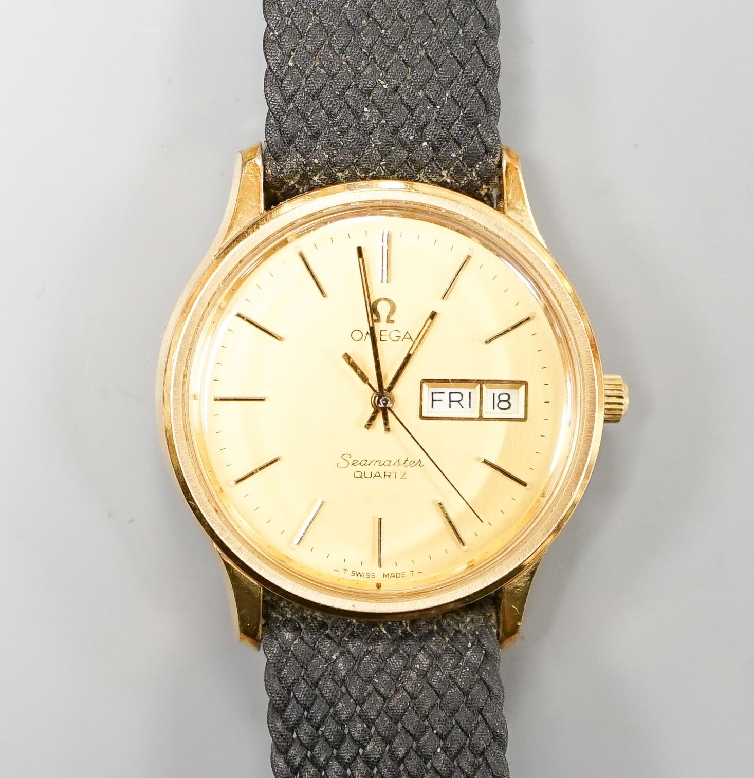 A gentleman's steel and gold plated Omega Seamaster quartz wrist watch, on associated fabric strap, no box or papers